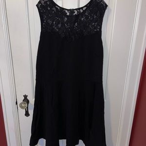 Mid-length black dress with lace.